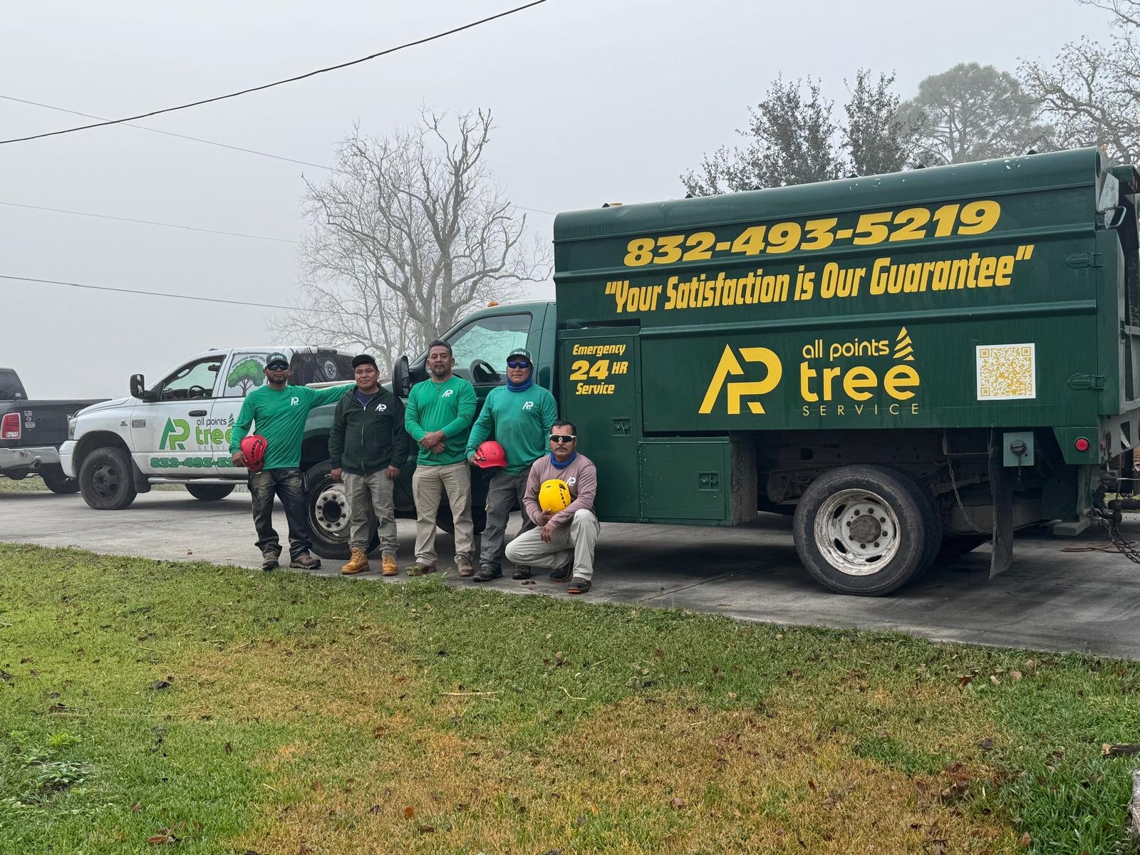 All Points Tree Service crew with branded work trucks